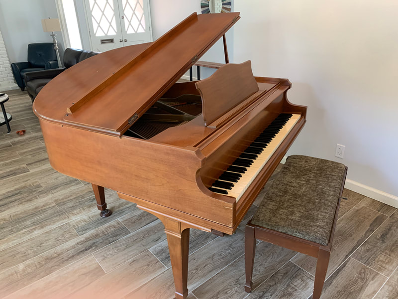 George Steck light brown grand piano